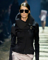 a photo from the gucci by tom ford fw 2003 show, showcasing a high neck asymmetric jacket